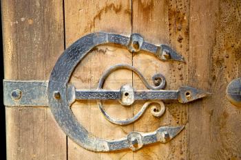 morocco knocker in africa the old wood  facade home and rusty safe padlock 