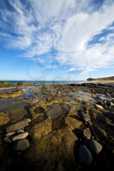 in lanzarote spain  rock stone sky cloud beach  water  musk pond  coastline and summer 
