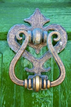  spain canarias brass brown knocker in a green closed wood  door  lanzarote abstract 
