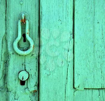 canarias brass brown knocker in a green closed wood  door  lanzarote abstract  spain 
