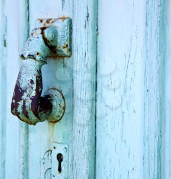 spain  hand brass knocker lanzarote abstract door wood in the grey
