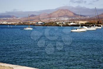 pier rusty chain  water  boat yacht coastline and summer in lanzarote spain
