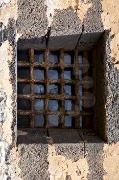 brown distorted  castle window in a broke   wall arrecife lanzarote spain
