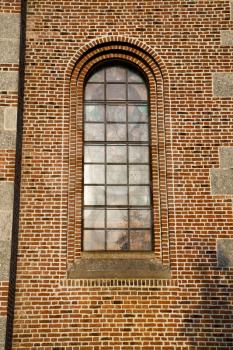  italy  lombardy     in  the  turbigo  old   church   closed brick tower   wall rose   window tile   