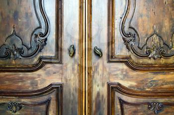 abstract  rusty brass brown knocker in a   closed wood door  lonate ceppino varese italy
