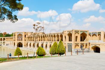 blu in iran  the old bridge and the river antique construction near nature