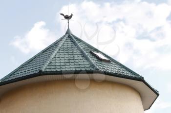 Detail of the round tower roof with a weathercock