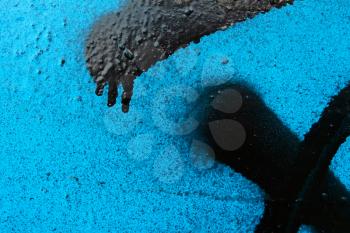 Fragment of metal surface with an abstraction of coated fresh blue and black dyes