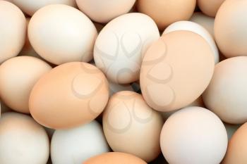 Multicolour heap of randomly stacked chicken eggs