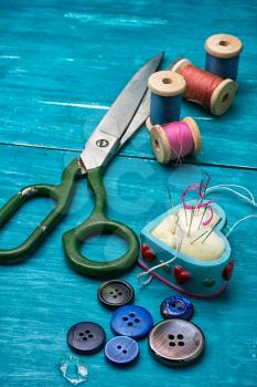 thread buttons for crafts on turquoise wooden background.Selective focus