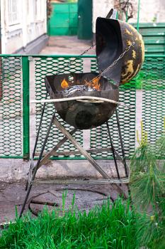improvised brazier with burning wood in it.