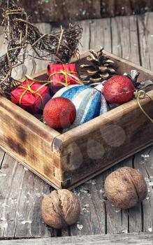 Stylish wooden box with Christmas decorations and pine cones