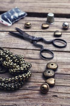 metal chain and beads for craft on wooden background