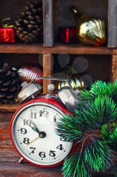 Clock alarm clock with bells on the background of Christmas decorations