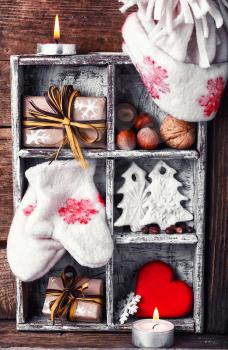 Stylish box with Christmas decorations of mittens, symbolic trees,hearts and gifts