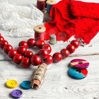 Red lace,beads and tools of the artisan jewelry.