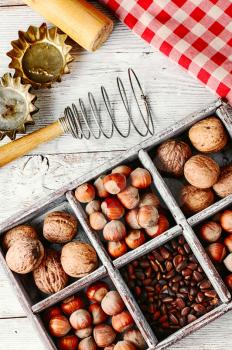 Wooden box with walnuts and pine nuts and hazelnuts
