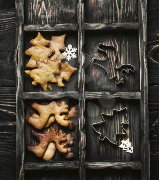 dark box of cookies in the shape of reindeer and Christmas trees for Christmas