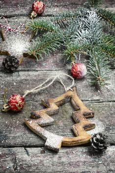 Christmas toy, vintage wooden Christmas tree on background with Christmas fir