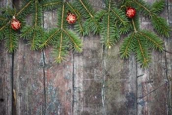 Retro wooden background with fir tree branches and Christmas decorations.Copy space