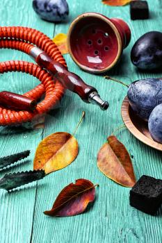 Smoking hookah accessories and tobacco with the taste of autumn plums