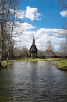 Ancient wooden temple stands on the banks of the river. Kostroma, Russia