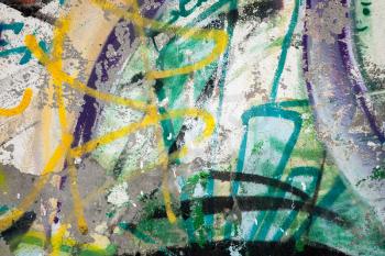 Abstract colorful paint graffiti fragment on gray urban concrete wall