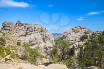 Wild mountain landscape with rocks under blue sky. South of Corsica island, France