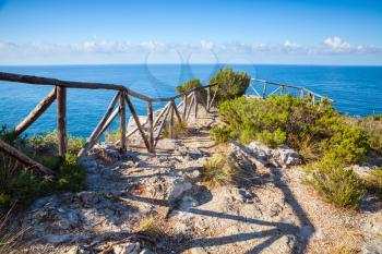 Wooden railing on rocky coast of Mediterranean sea, Gaeta commune, Italy