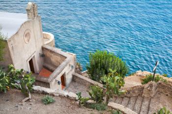 Small church on Mediterranean sea coast near Aragonese Castle. Ischia Porto, Bay of Naples, Italy