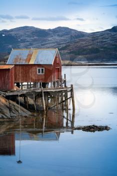 Red wooden house on the sea coast in Norway