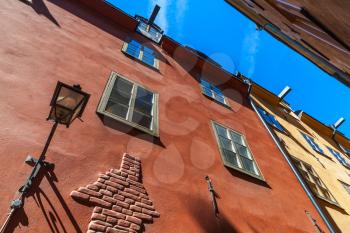 Old red house facade with street lamp. Gamla stan, the old town in central Stockholm, Sweden