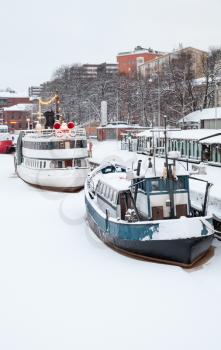 Small ships are moored near river coast in Turku town, Finland