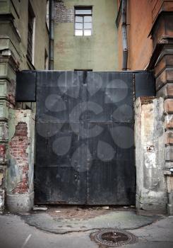 Old locked black metal square gate in old part of St.Petersburg, Russia