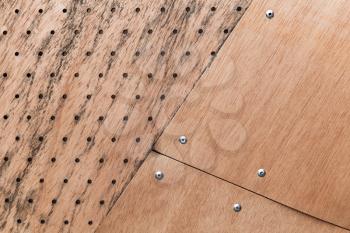 Structure made of plywood sheets and rivets, background photo texture