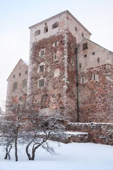 Vertical photo of Turku Castle in winter season. Medieval building in the city of Turku in Finland. It was founded in the late 13th century and stands on the banks of the Aura River