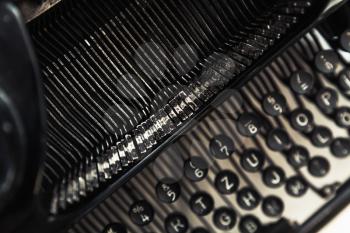 Vintage manual typewriter machine, closeup fragment with letters and keys, photo with soft selective focus