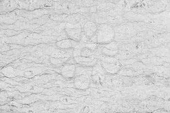 Gray concrete wall with decorative stucco relief pattern, background photo texture