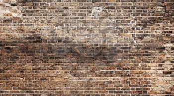 Old grungy dark brick wall, background photo texture
