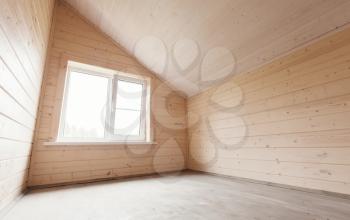 Attic room empty interior, new wooden walls and window