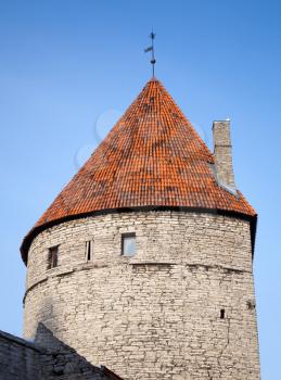 Ancient stone tower with red tiled roof. Fortress in old town of Tallinn, Estonia