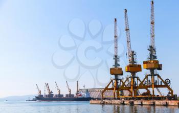 Cargo cranes stand on the pier in Burgas harbor. Black Sea coast, Bulgaria