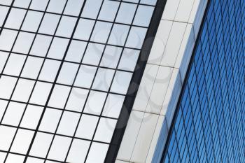 Modern business architecture, abstract fragment, corner of walls made of glass and steel with reflections
