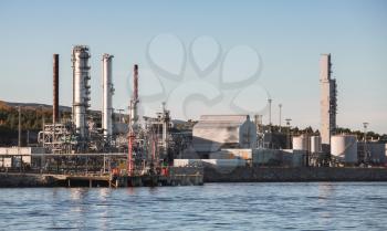 Norwegian oil plant, coastal industrial landscape in morning sunlight