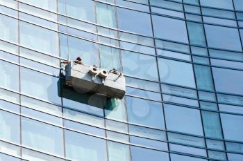 Office building maintenance, glass facade cleaning with cradle