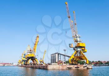 Port cranes in port of Burgas city, Bulgaria. Seaside view