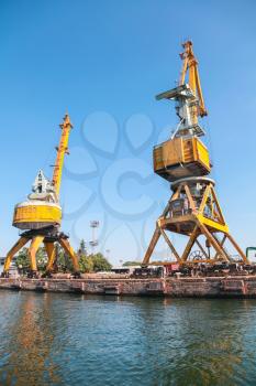 Yellow port cranes. Cargo port of Burgas city, Bulgaria. Seaside view