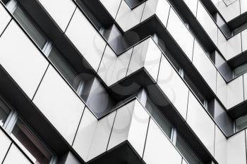 Abstract modern architecture background, corners pattern, shiny walls of steel with dark windows