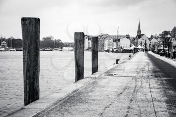 Coastal street in winter town. Flensburg, Germany. Black and white photo