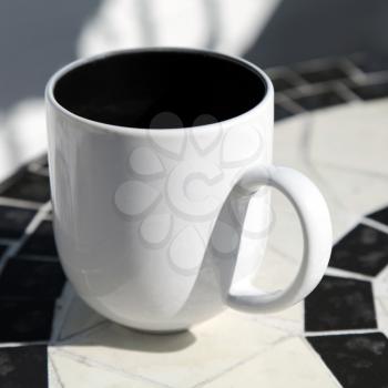 White coffee cup stands on round table